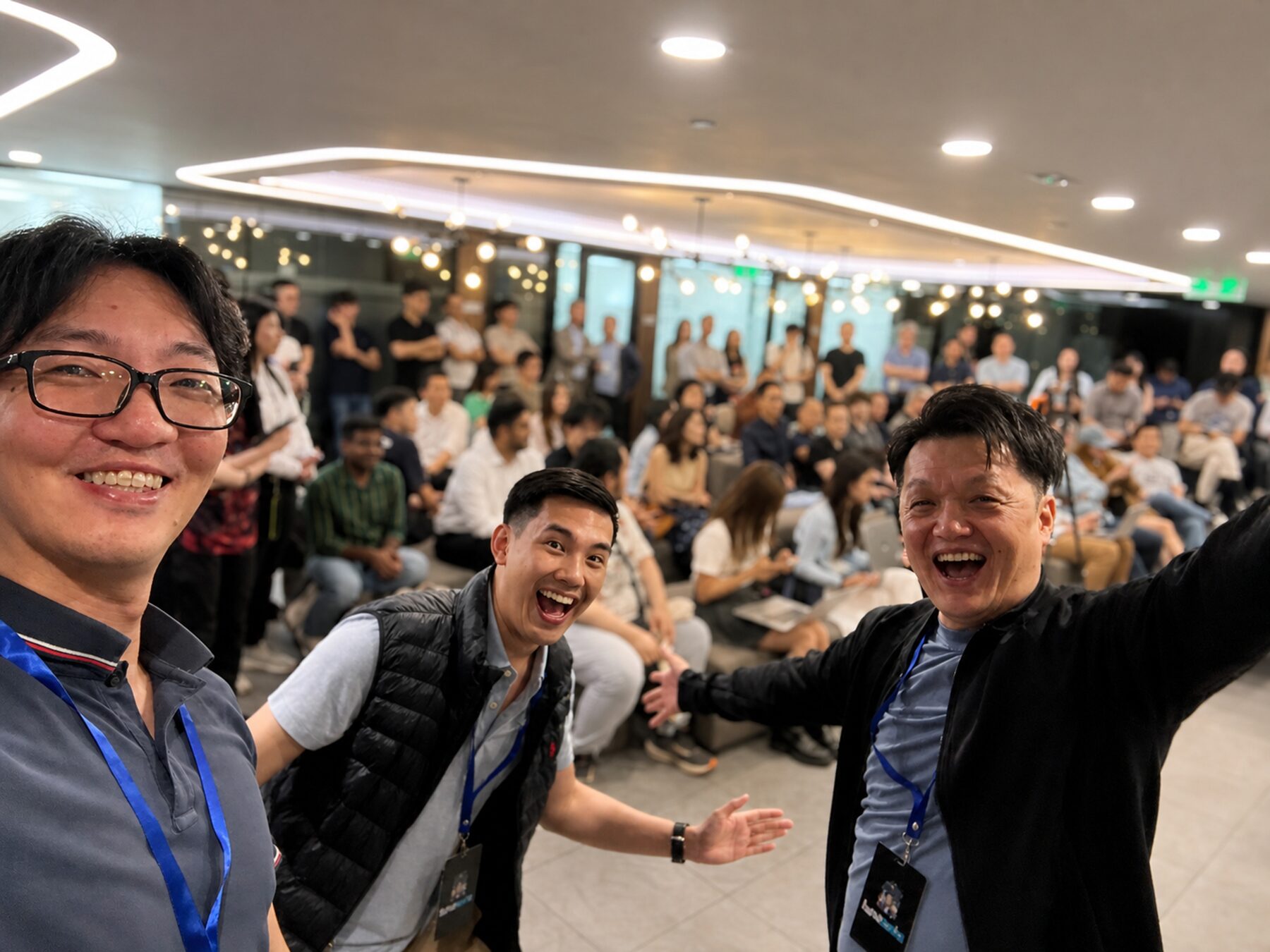 Three Lunatechs attendees smiling in front of the packed room