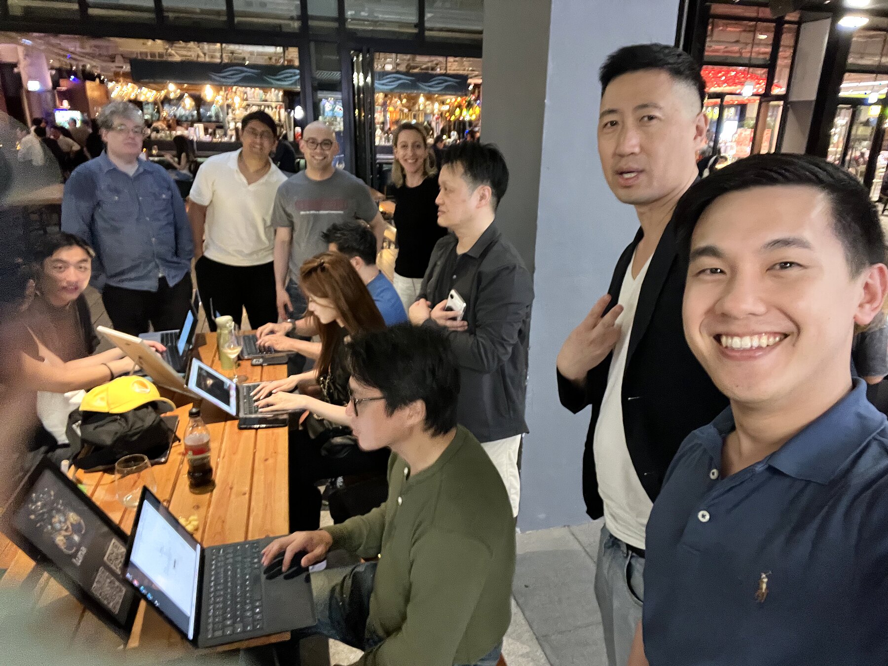 Organizers and attendees around a laptop table during the event