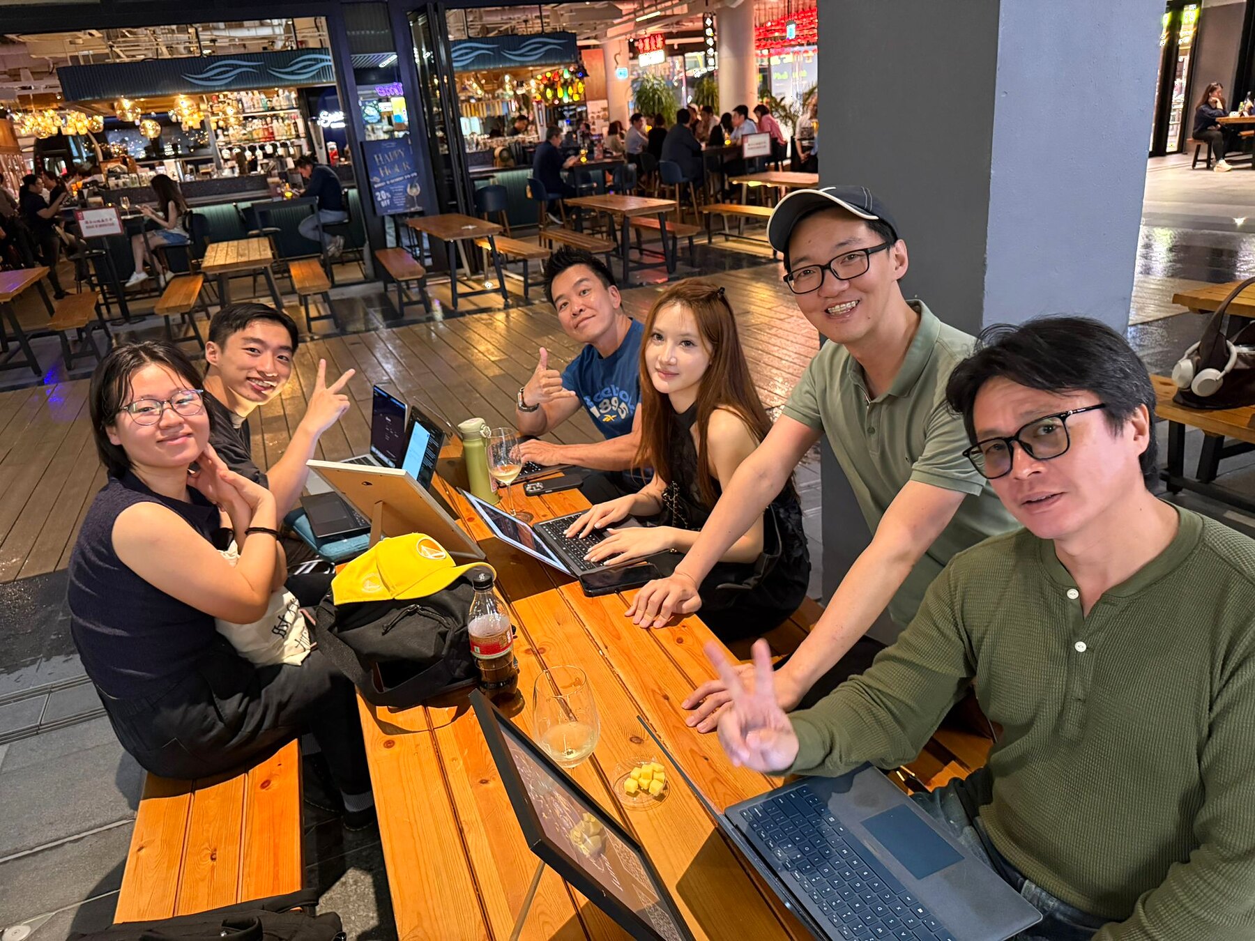 Small group smiling at a laptop table during Boba and Tech