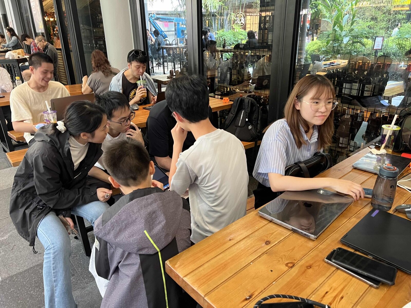 Claude Code Community Day attendees working at outdoor tables in Central Market