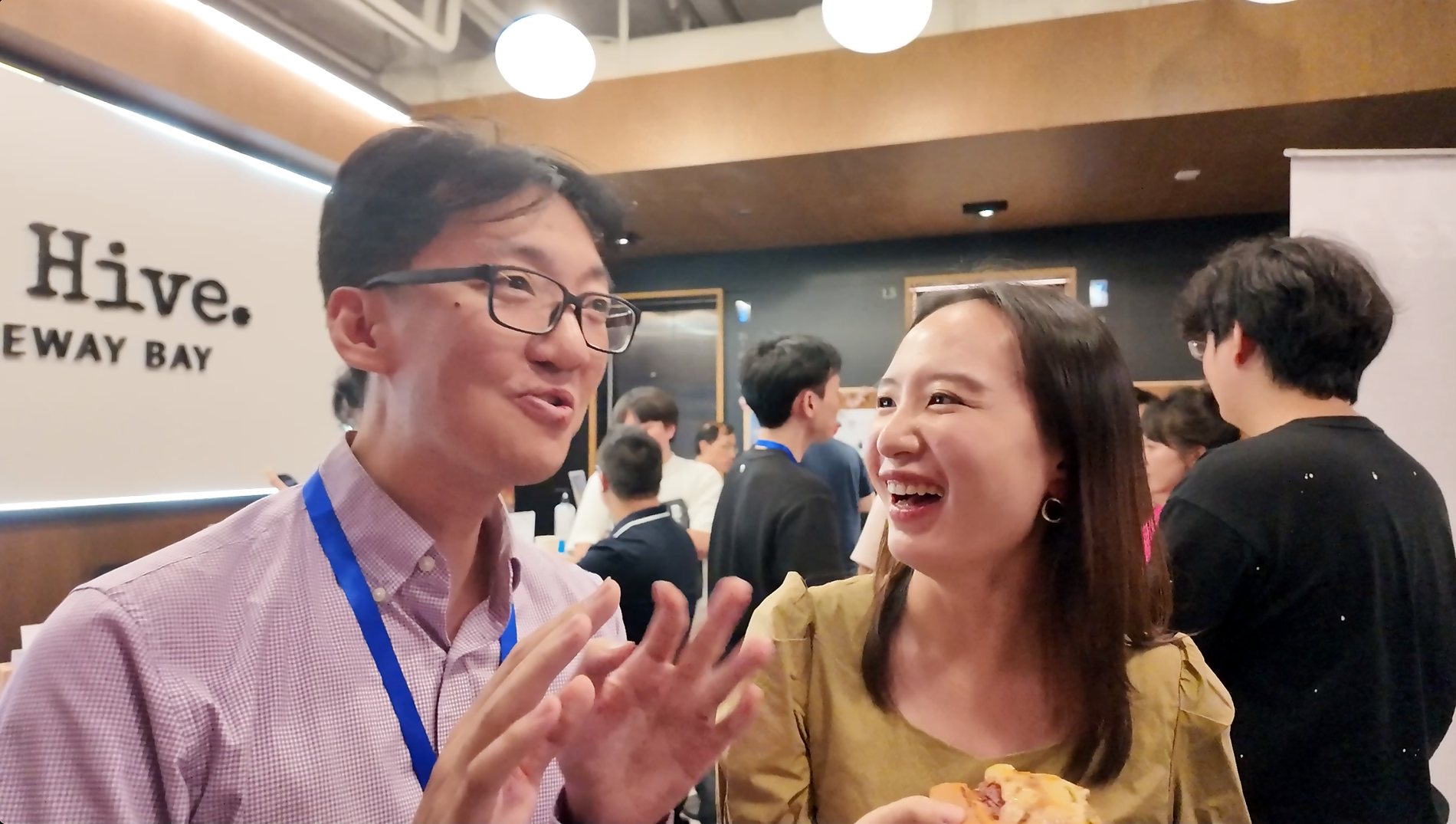 Two attendees laughing during the Lunatechs AI video event
